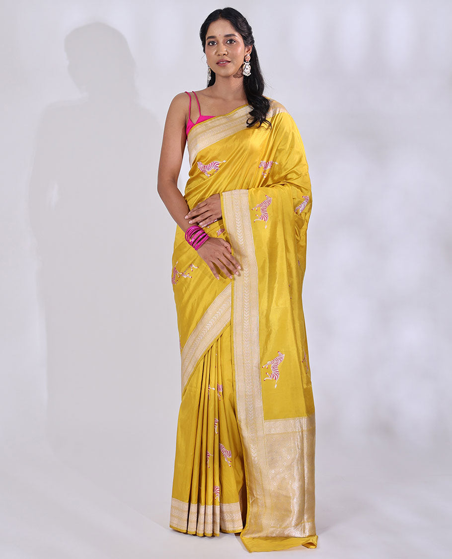 Yellow Banarasi Silk Saree Elevated with Zebra Motifs All Over Its Body, a Subtle Border of Traditional Designs, Pallu Decked Up with Floral and Diamond Designs, and Paired with a Matching Blouse