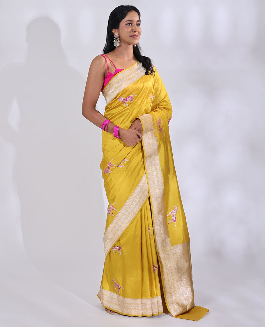 Yellow Banarasi Silk Saree Elevated with Zebra Motifs All Over Its Body, a Subtle Border of Traditional Designs, Pallu Decked Up with Floral and Diamond Designs, and Paired with a Matching Blouse