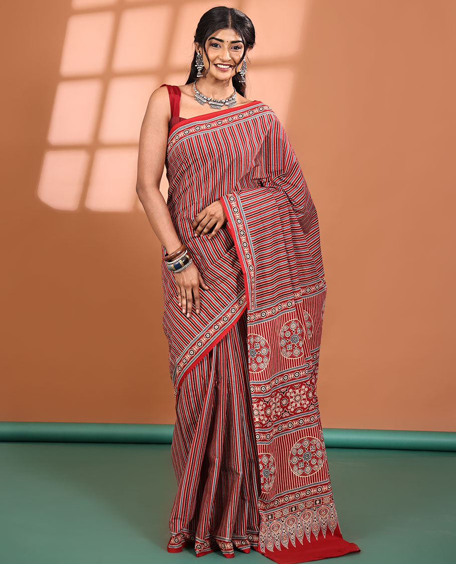Red-base Saree, Subtly Sparkled with Vertical Stripes All Across Its Body, Highlighted by Floral Ajrakh-style Printed Border, Ajrakh Printed Pallu, and Paired with a Matching Blouse