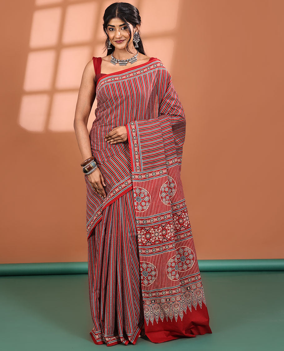 Red-base Saree, Subtly Sparkled with Vertical Stripes All Across Its Body, Highlighted by Floral Ajrakh-style Printed Border, Ajrakh Printed Pallu, and Paired with a Matching Blouse