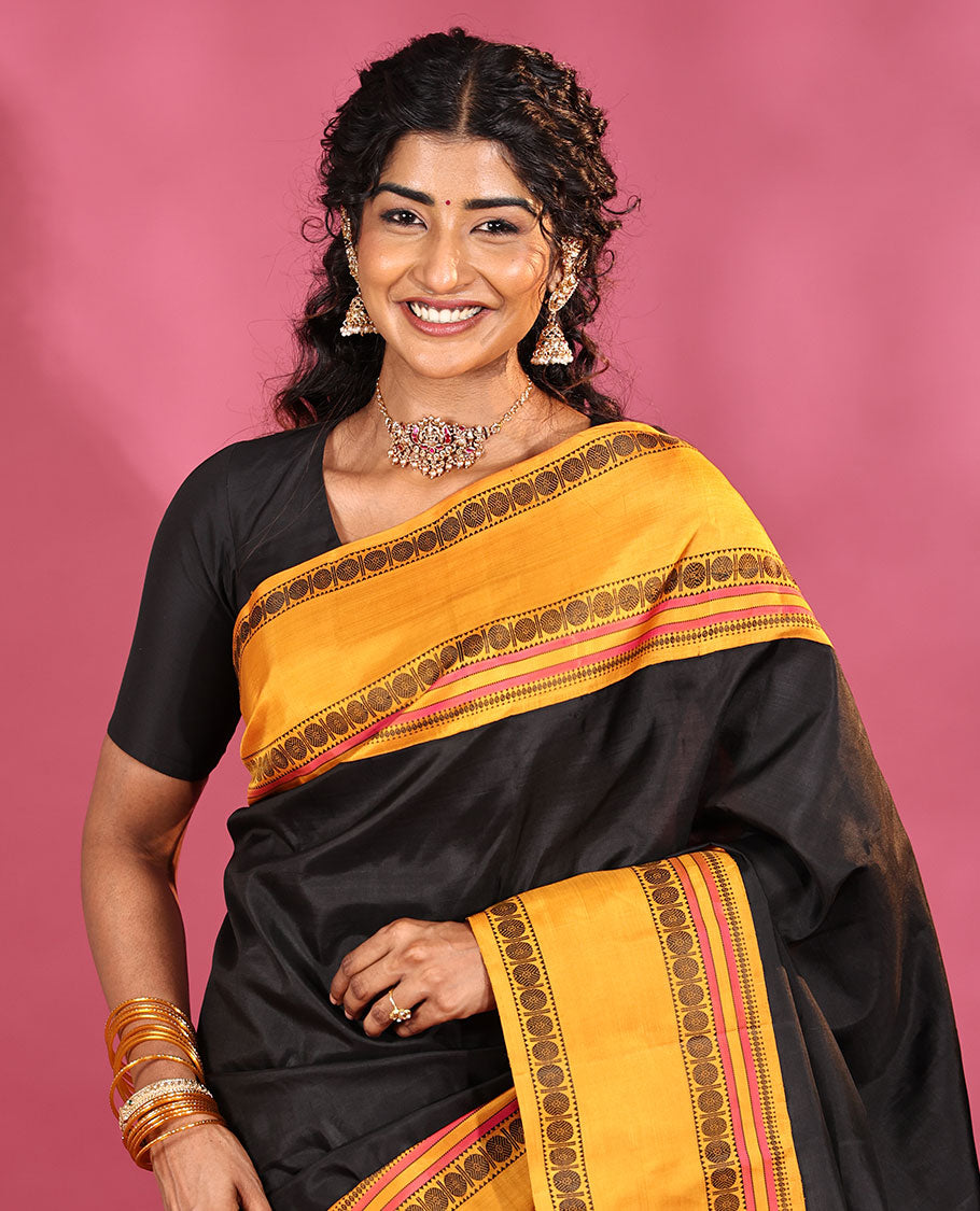 Black Plain Kanchipuram Silk Saree, Complemented by Captivating Contrast Rettai Pettu Border of Rekku, Muthu, and Rudraksham Designs, a Subtle Pallu of Thread Weave, and Paired with a Contrast Blouse
