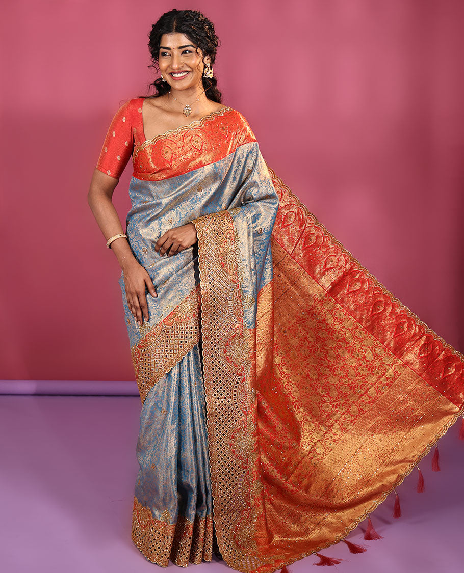 Blue Vastrakala Silk Saree, Adorned with Floral Jacquard and Stone Work, Complemented by Contrast Traditional Zari and Cut Embroidered Scallop Border, Gleaming Grand Zari-Stone Work Pallu, and Paired with Contrast Heavy Stone Embroidered Blouse