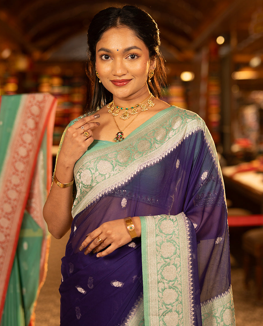 Purple Banarasi Georgette Saree, Accentuated with Zari Buttas All Over Its Body, Complemented by a Contrast Floral Creeper Design Border, Pallu of Paisleys, and Paired with a Contrast Blouse