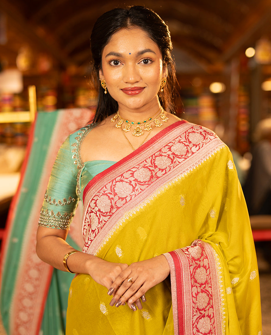 Mustard Banarasi Georgette Saree, Ornamented with Zari Buttas All Over Its Body, Complemented by a Contrast Floral Creeper Design Border, Pallu of Paisleys, and Paired with a Contrast Blouse