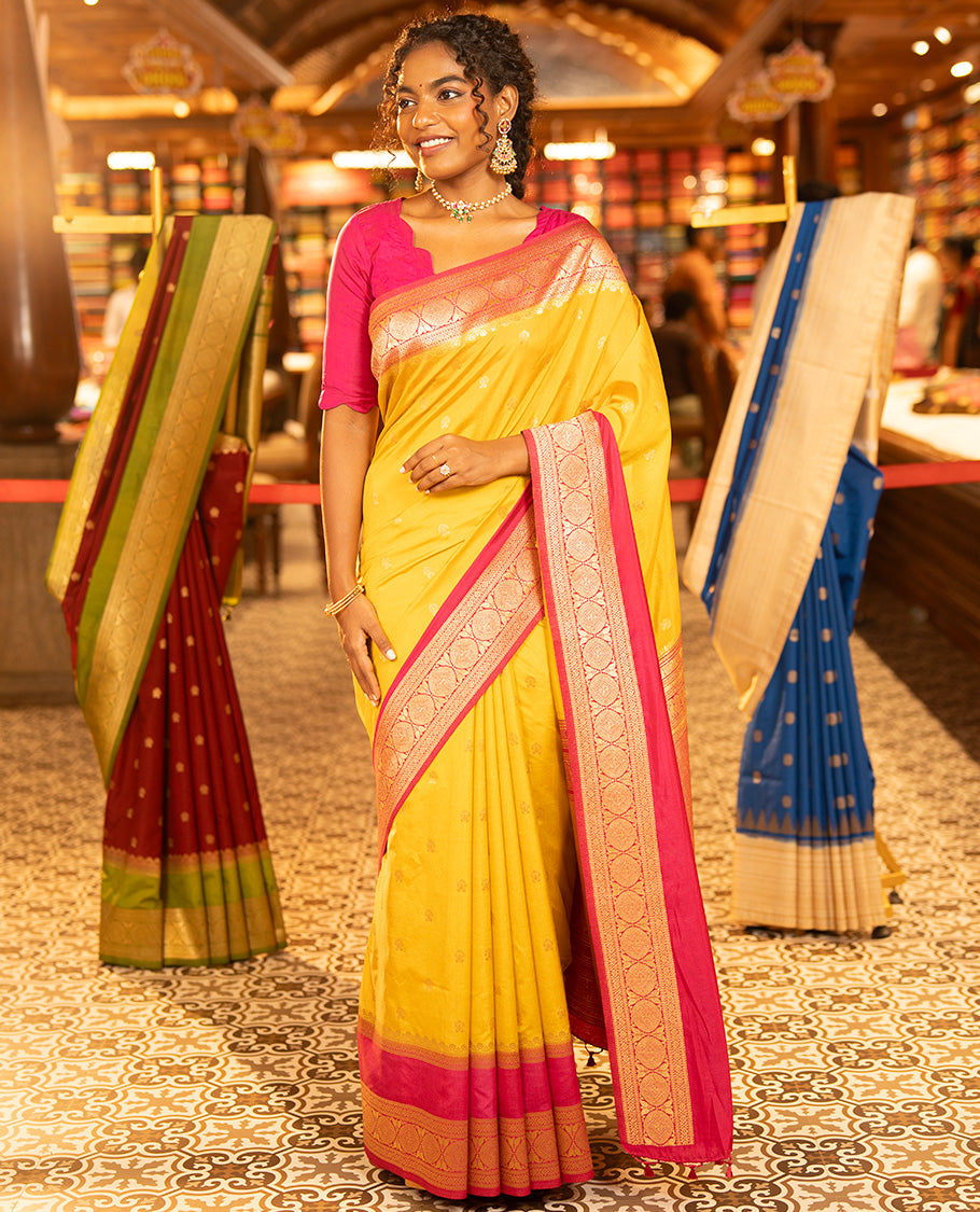 Mustard Yellow Dupion Silk Saree, Embellished with Buttas All Over Its Body, Complemented by Contrast Traditional Border of Paisleys and Chakram Designs, Intricately Designed Pallu, and Paired with a Contrast Blouse