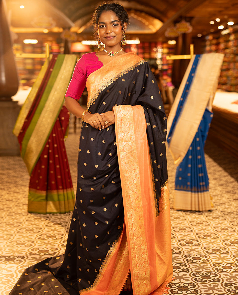 Navy Blue Dupion Silk Saree, Adorned with Buttas All Over Its Body, Complemented by Contrast Traditional Border of Paisleys and Chakram Designs, Intricately Designed Pallu, and Paired with a Contrast Blouse