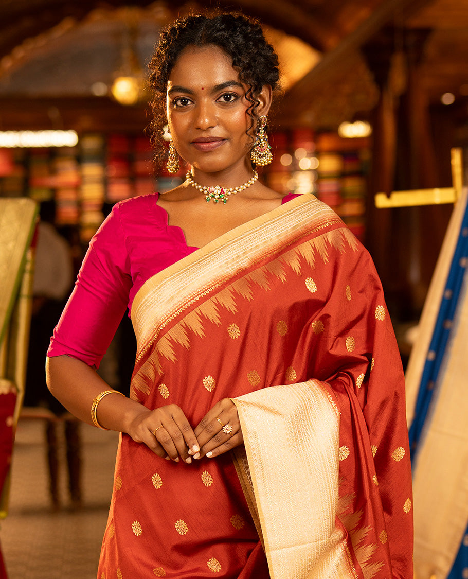 Rust Dupion Silk Saree, Decked Up with Zari Buttas All Over Its Body, Complemented by a Contrast Temple Traditional Zari Design Woven Border, Traditional Pallu of Temple Designs, and Paired with a Contrast Blouse