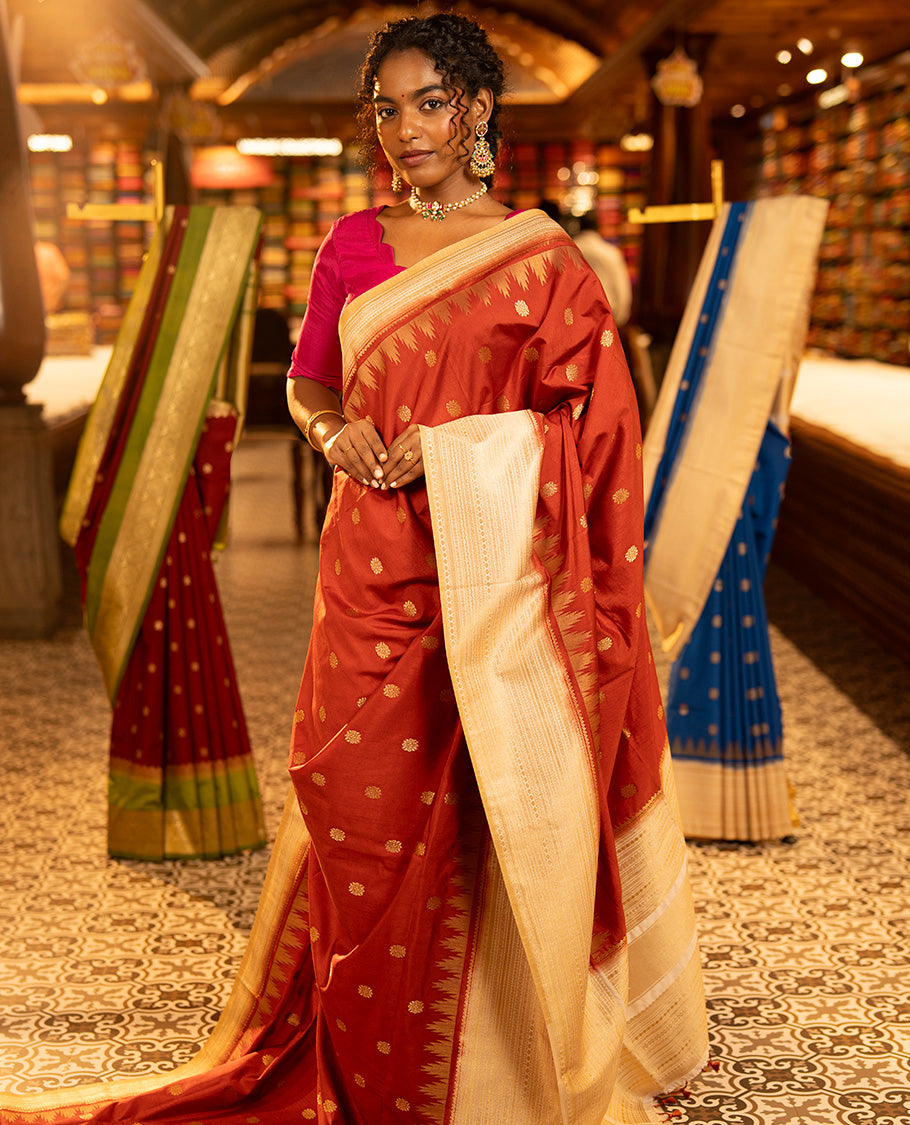 Rust Dupion Silk Saree, Decked Up with Zari Buttas All Over Its Body, Complemented by a Contrast Temple Traditional Zari Design Woven Border, Traditional Pallu of Temple Designs, and Paired with a Contrast Blouse