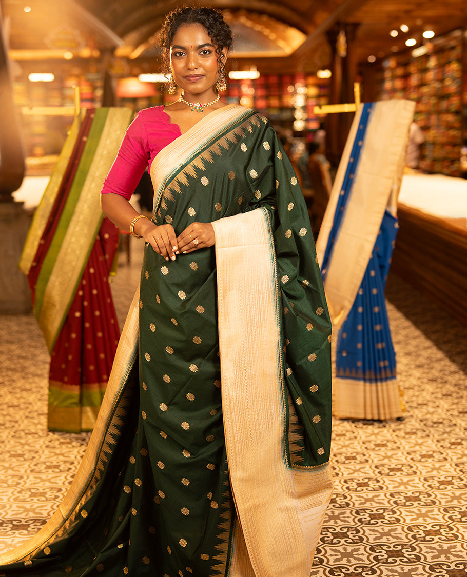 Bottle Green Dupion Silk Saree, Elevated with Zari Buttas All Over Its Body, Complemented by a Contrast Temple Traditional Zari Design Woven Border, Traditional Pallu of Temple Designs, and Paired with a Contrast Blouse