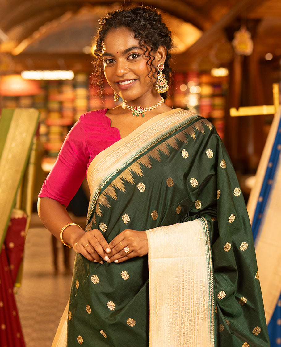 Bottle Green Dupion Silk Saree, Elevated with Zari Buttas All Over Its Body, Complemented by a Contrast Temple Traditional Zari Design Woven Border, Traditional Pallu of Temple Designs, and Paired with a Contrast Blouse