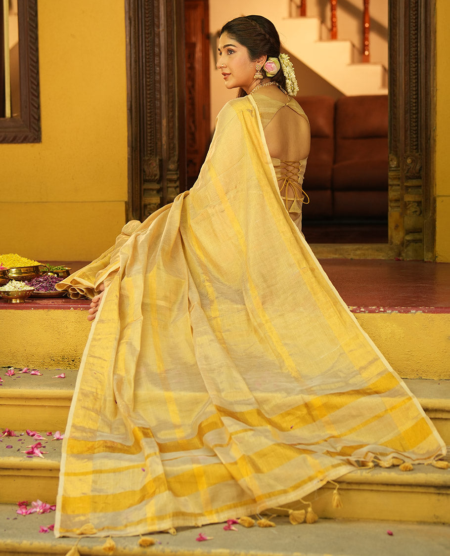 Gleaming Gold Khadi Tissue Saree, Elevated with Zari Stripes All Over Its Body, Highlighted by Zari Bavanji Border, Zari Striped Pallu, and Paired with a Matching Blouse