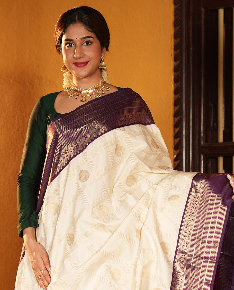 Off-White and Purple Budget Silk Saree, Bedecked with Zari Butta Enclosed Checks on Its Body, Complemented by a Contrast Traditional Zari Design Border of Paisleys, Grand Jaal Pallu, and Paired with a Contrast Blouse