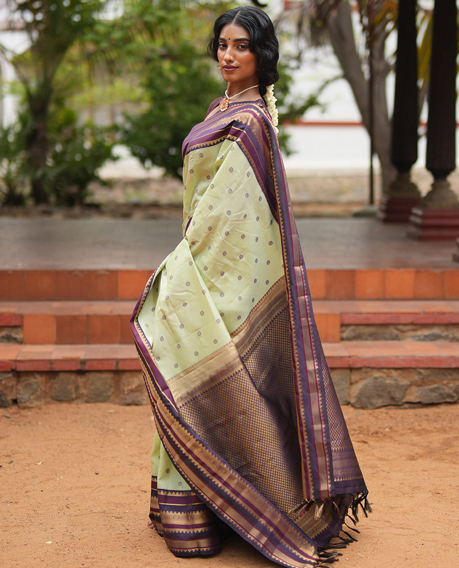 Pista Green and Coffee Brown Vasundenhara Lite Silk Mix Saree, Subtly Adorned with Buttas All Over Its Body, Complemted by Contrast Border of Thazampoo Rekku, Banaras, Jada Nagam, and Ara Maadam Designs, Grand Pallu, and Paired with a Contrast Blouse