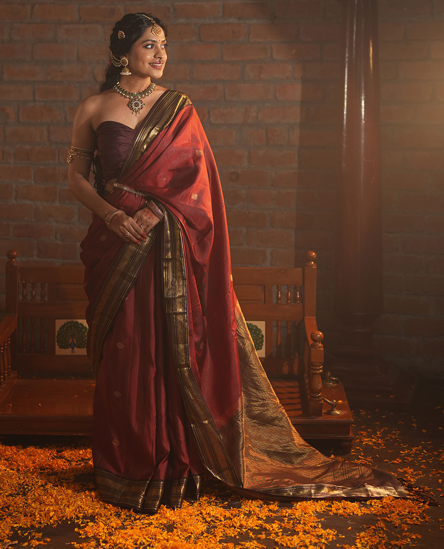 Crimson Red Vasundhara Silk Saree Featuring Vaira Oosi, and Annam Chakram Buttas, Complemented by a Contrast Border of Thilakam, Banaras, Mayil, Mayil Kann, Ara Bogudi, Muthu, and Banaras Designs, Grandly Woven Pallu, and a Contrast Blouse