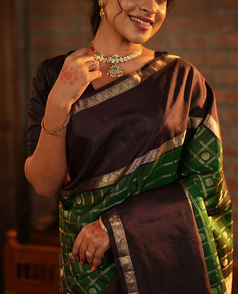 Green Vasundhara Silk Saree Richly Detailed with Chakram Butta Enclosed Checks, Highlighted with a Contrast Rettai Pettu of Rekku, Muthu, and Dhavana Kodi Designs, Zari-Rich Pallu of Jaal Designs, and Paired with a Contrast Blouse