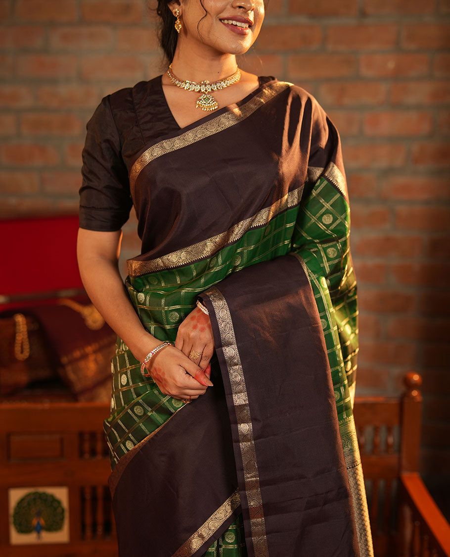 Green Vasundhara Silk Saree Richly Detailed with Chakram Butta Enclosed Checks, Highlighted with a Contrast Rettai Pettu of Rekku, Muthu, and Dhavana Kodi Designs, Zari-Rich Pallu of Jaal Designs, and Paired with a Contrast Blouse