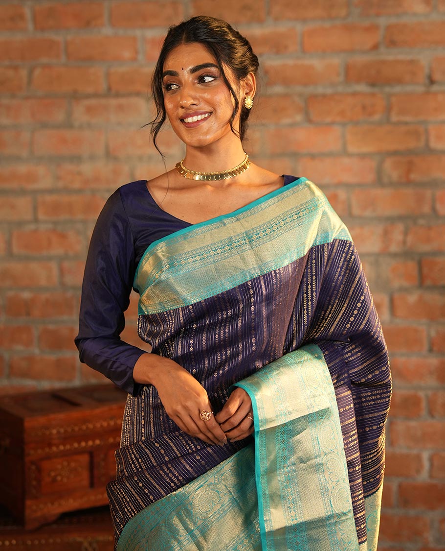 Blue Vasundhara Silk Saree Adorned with Jacquard Design Weave All Over Its Body, Complemented by a Contrast Border of Rekku, Muthu, Laddu Kamalam, Then Kuli Kann, and Dhavana Kodi Designs, Artfully Zari Woven Pallu, and Paired with a Contrast Blouse
