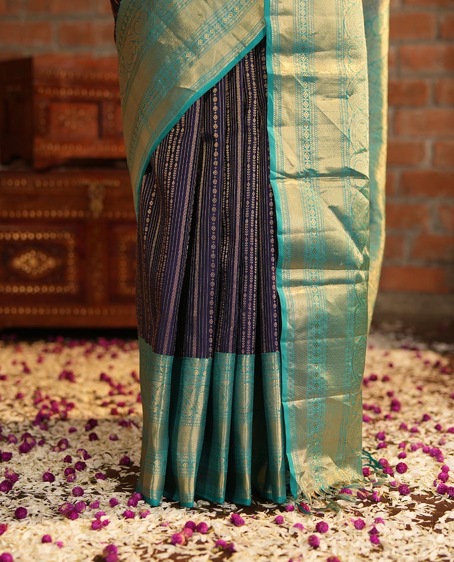 Blue Vasundhara Silk Saree Adorned with Jacquard Design Weave All Over Its Body, Complemented by a Contrast Border of Rekku, Muthu, Laddu Kamalam, Then Kuli Kann, and Dhavana Kodi Designs, Artfully Zari Woven Pallu, and Paired with a Contrast Blouse