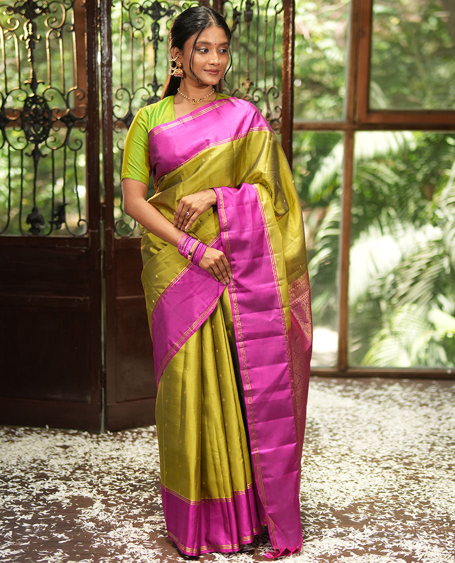 Green Vasundhara Lite-Silk Mix Saree, Beautifully Decorated with Zari Buttas All Over Its Body, Complemented by Contrast Rettai Pettu Border of Zari Stripes, Pallu Accentuated with Jaal Designs, and Paired with a Contrast Blouse