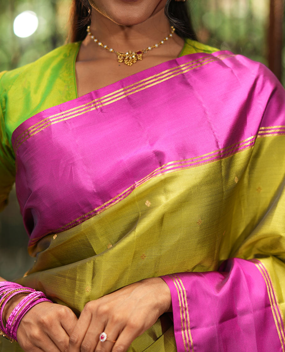 Green Vasundhara Lite-Silk Mix Saree, Beautifully Decorated with Zari Buttas All Over Its Body, Complemented by Contrast Rettai Pettu Border of Zari Stripes, Pallu Accentuated with Jaal Designs, and Paired with a Contrast Blouse