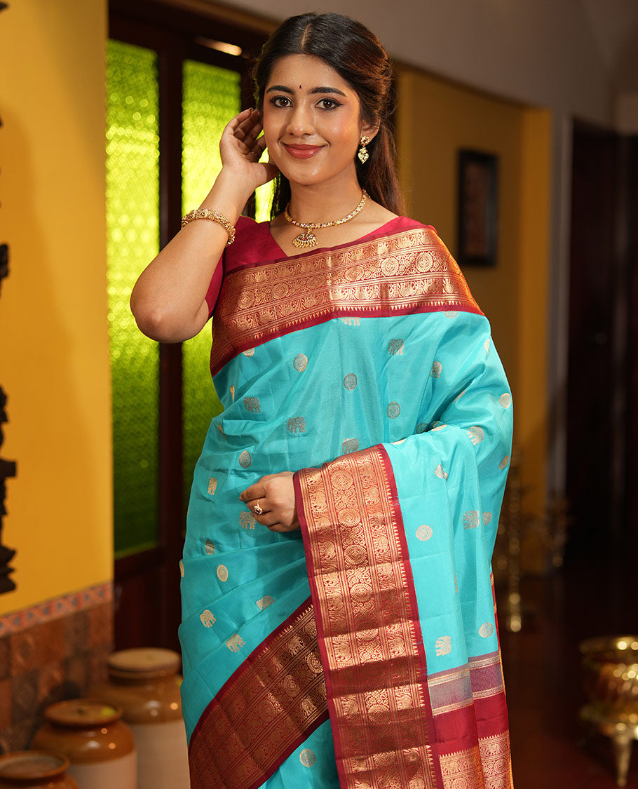 Blue Vasundhara Silk Saree, Embellished with Mayil and Yaanai Buttas Across Its Body, Complemented by a Contrast Korvai Border of Rekku, Banaras, Yaanai, and Chakram Designs, Gleaming Jaal Pallu, and Paired with a Contrast Blouse