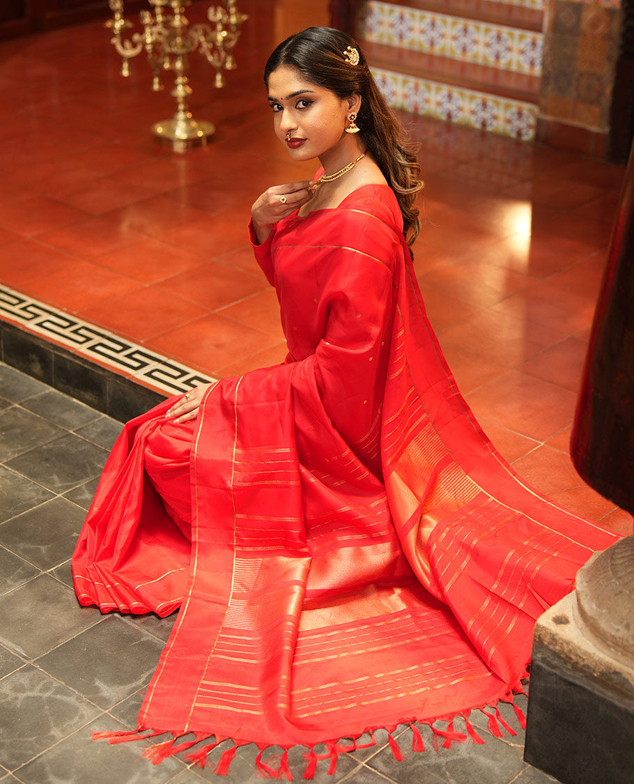 Red Vasundhara Lite Silk Saree, Subtly Sparkled with Paisa Zari Buttas Across Its Body, Highlighted Zari Border of Horizontal Stripes, Gleaming Pallu of Seppu Rekku Designs, and Paired with a Matching Blouse