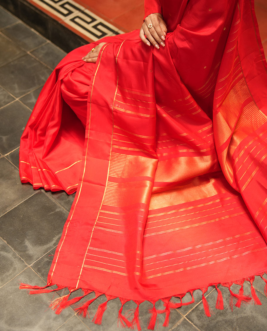 Red Vasundhara Lite Silk Saree, Subtly Sparkled with Paisa Zari Buttas Across Its Body, Highlighted Zari Border of Horizontal Stripes, Gleaming Pallu of Seppu Rekku Designs, and Paired with a Matching Blouse