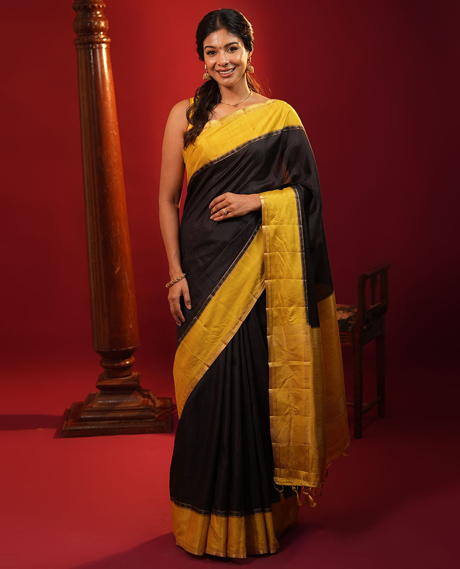 Black Plain Semi-Tussar Silk Saree, Complemented by a Contrast Geometric Design Border, Subtly Zari Striped Pallu, and Paired with a Contrast Floral Vine Printed Blouse