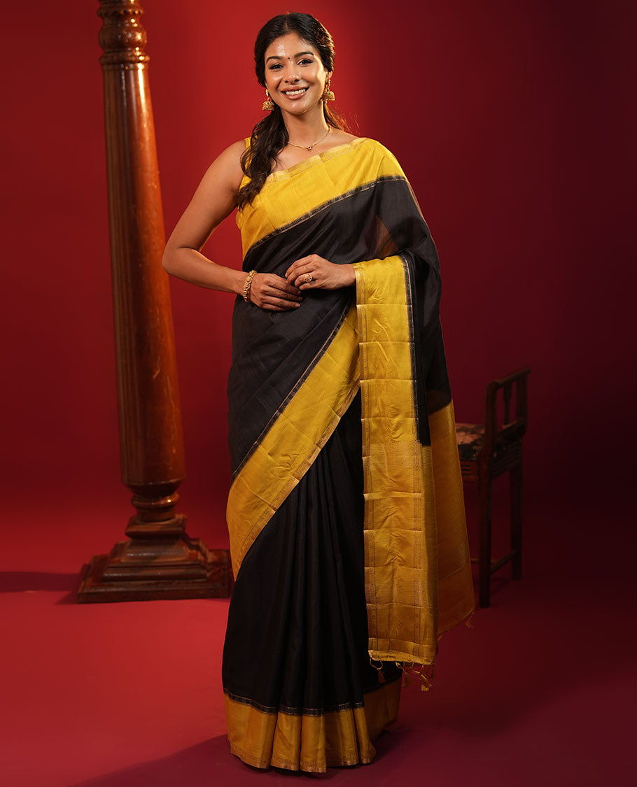 Black Plain Semi-Tussar Silk Saree, Complemented by a Contrast Geometric Design Border, Subtly Zari Striped Pallu, and Paired with a Contrast Floral Vine Printed Blouse