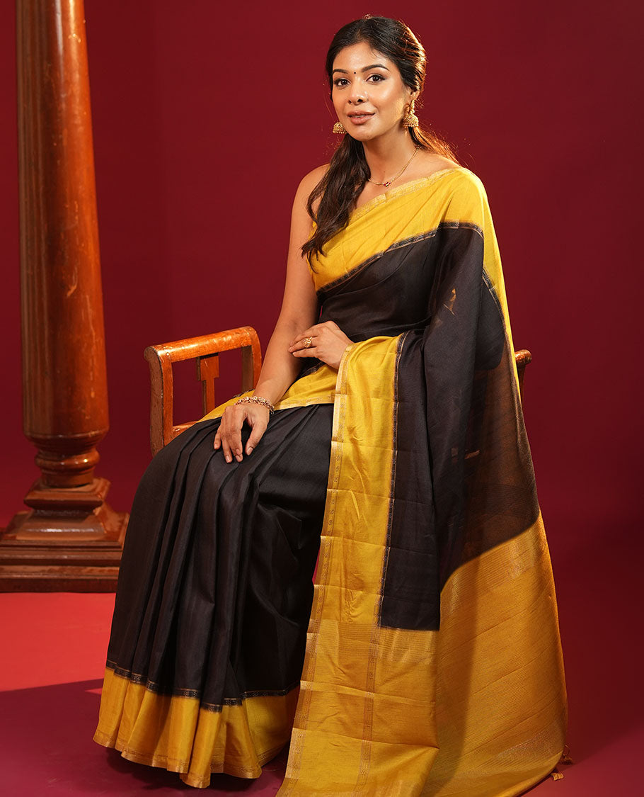 Black Plain Semi-Tussar Silk Saree, Complemented by a Contrast Geometric Design Border, Subtly Zari Striped Pallu, and Paired with a Contrast Floral Vine Printed Blouse
