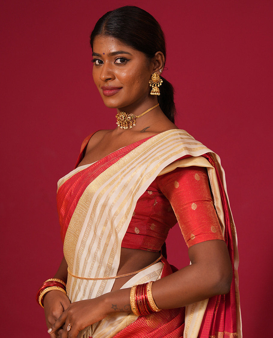 Orange muthu kattam and zari buttas silk saree, contrast varisai pettu border of thilakam, muthu, and rudraksham designs, and jaal pallu