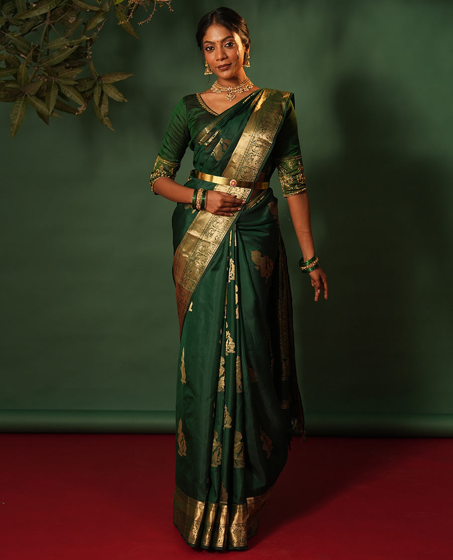 Green singam and yaanai zari buttas woven silk saree, zari border of mayil kann, rudraksham, muthu, mayil, and yaali designs, and intricate pallu