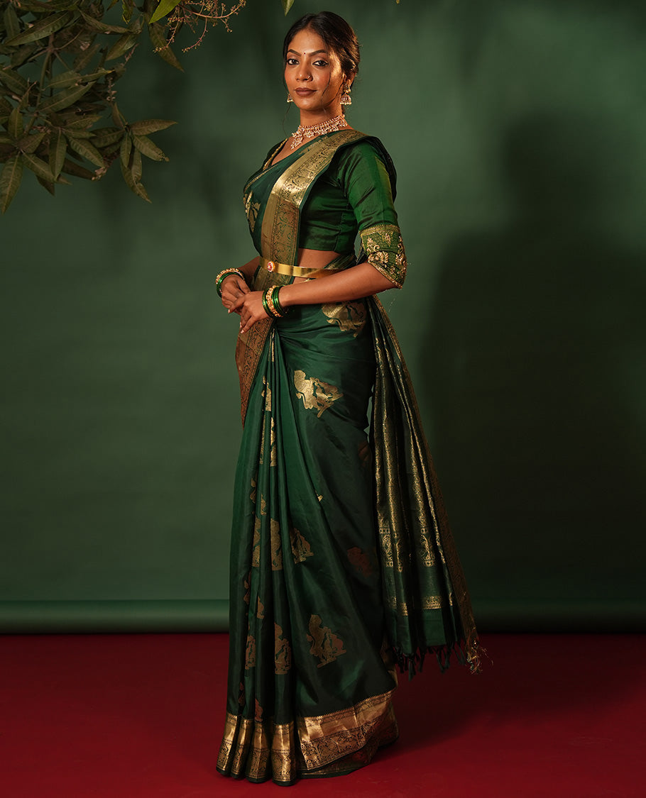 Green singam and yaanai zari buttas woven silk saree, zari border of mayil kann, rudraksham, muthu, mayil, and yaali designs, and intricate pallu