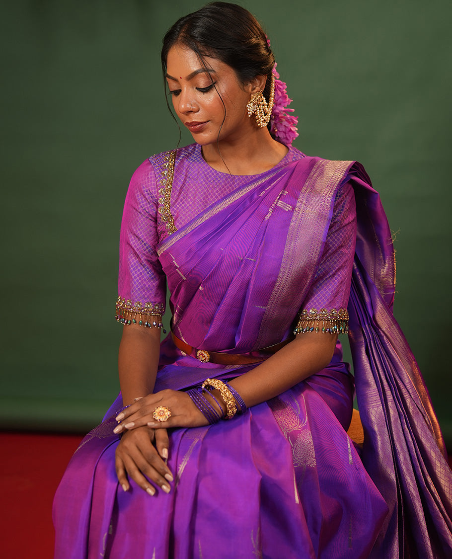 Violet Vasundhara Silk Saree Accentuated with Thazampoo Rekku, and Vel Buttas, Complemented by Zari Border of Manga, Muthu, Kathir, Neli, and Vanki Designs, Pallu Adorned with Jaal Designs, and Paired with a Matching Blouse