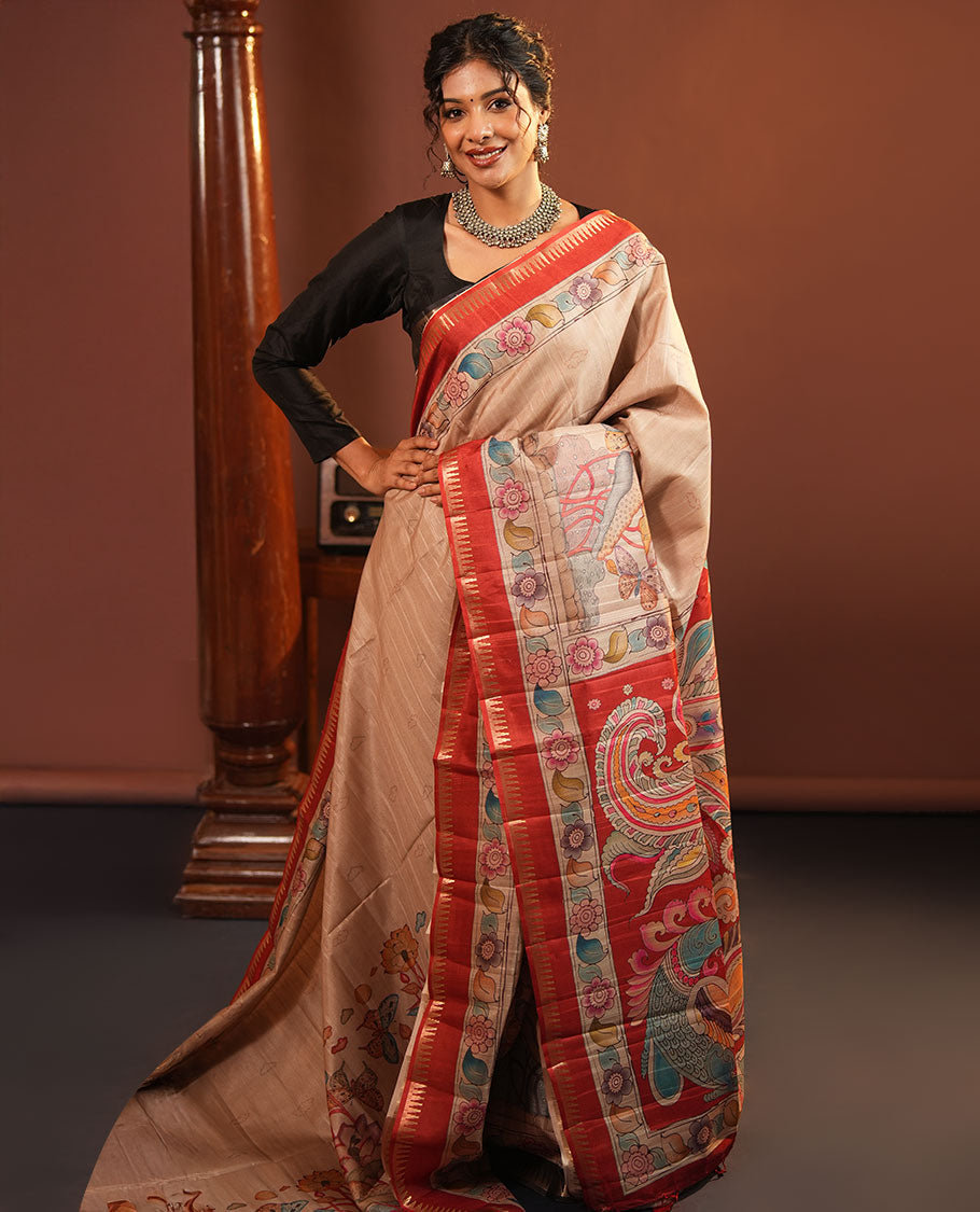 Chikku-Red Fancy Tussar Saree, Artfully Detailed with Kalamkari-Style Floral Print Across Its Body, Complemented by Contrast Temple Zari Border, a Colourfully Kalamkari Printed Pallu, and Paired with a Plain Blouse