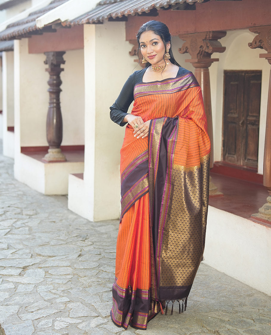 Orange Vasundhara Lite Silk Saree, Subtly Detailed with Stripes, Complemented by a Contrast Rettai Pettu Border of Salngai, Cross Kamalam, Muthu, Kathir, Diamond, and Arumbu Manga Designs, Grand Jaal Pallu, and Paired with a Contrast Blouse