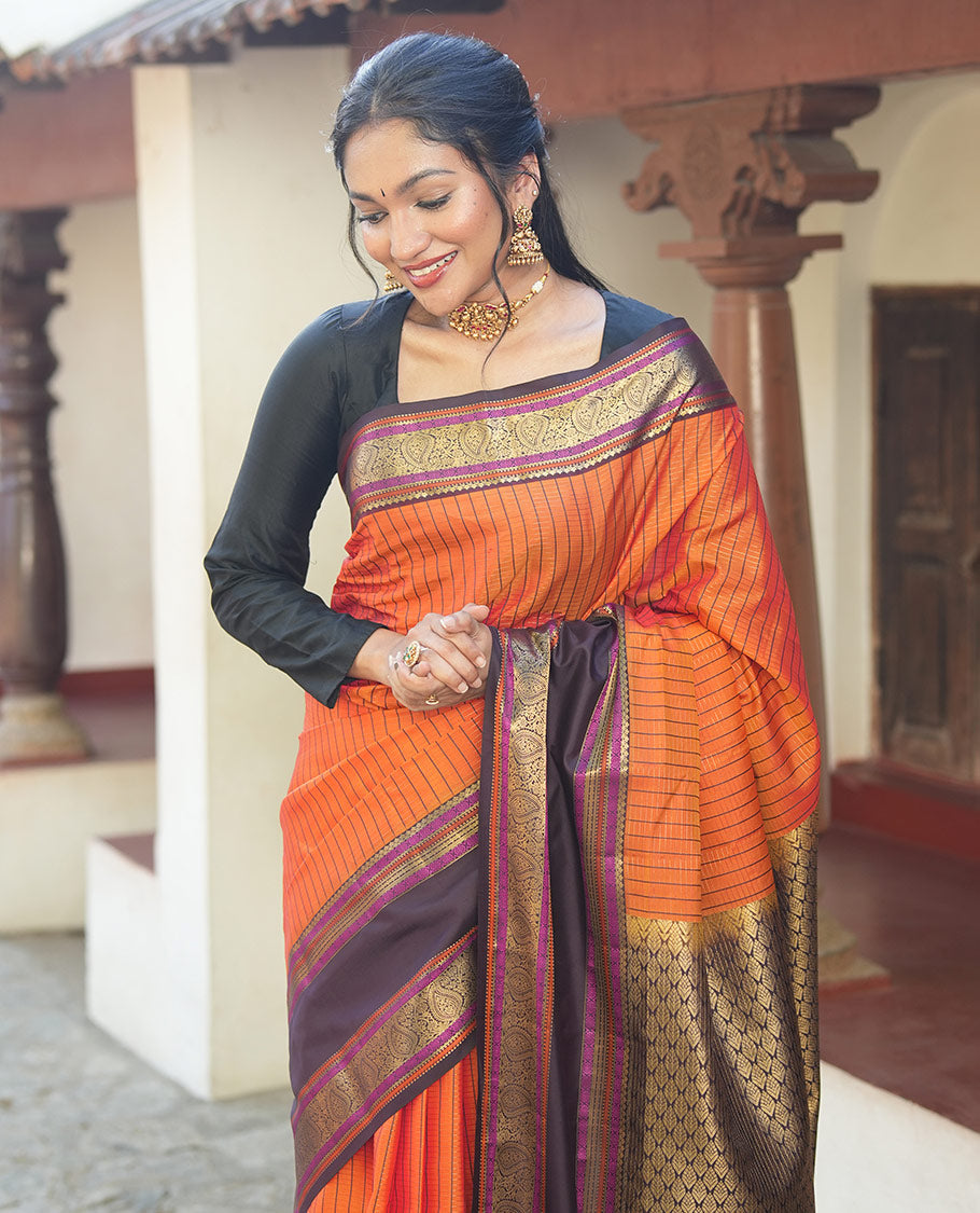 Orange Vasundhara Lite Silk Saree, Subtly Detailed with Stripes, Complemented by a Contrast Rettai Pettu Border of Salngai, Cross Kamalam, Muthu, Kathir, Diamond, and Arumbu Manga Designs, Grand Jaal Pallu, and Paired with a Contrast Blouse