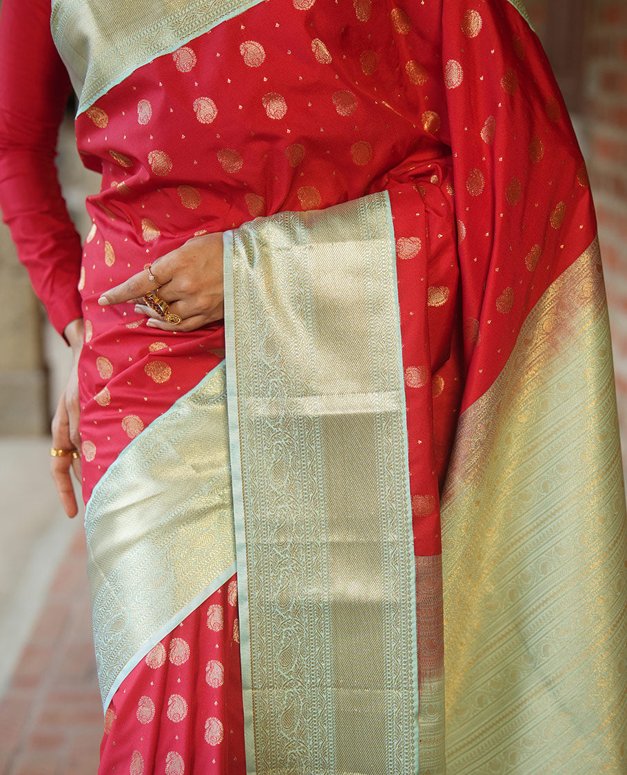 Red BudgetSilk Saree, Spotlighted with Zari Buttas All Over Its Body, Complemented by a Contrast Border of Banaras, Muthu, Kodi Visiry and Kodi Manga Designs, Pallu Steeped with Kodi Manga Designs, and Paired with a Contrast Blouse
