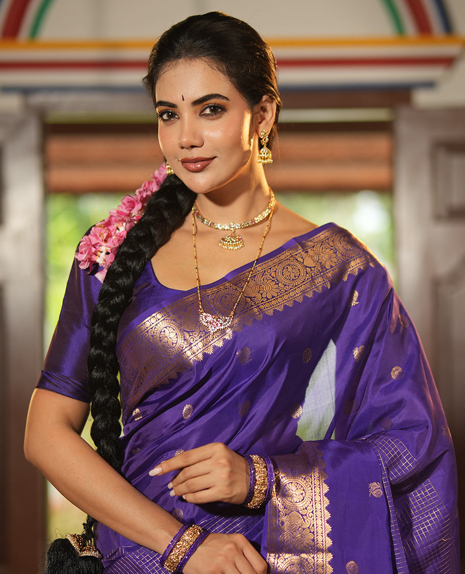 Violet Vasundhara Lite Silk Mix Saree, Artfully Detailed with Mayil-Chakram Buttas and Zari Checks All Over Its Body, Highlighted by a Zari Border of Thazampoo Rekkum, Paisa, Mayil, and Chakram Designs, a Grand Pallu, and Paired with a Matching Blouse