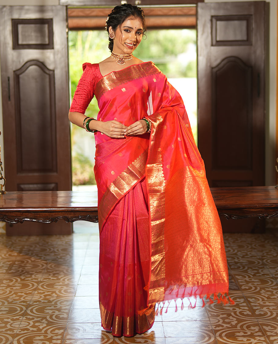 Pink Vasundhara Lite Silk Mix Saree, Artfully Detailed with Mayil-Chakram Buttas and Zari Checks All Over Its Body, Highlighted by a Zari Border of Thazampoo Rekkum, Paisa, Mayil, and Chakram Designs, a Grand Pallu, and Paired with a Matching Blouse