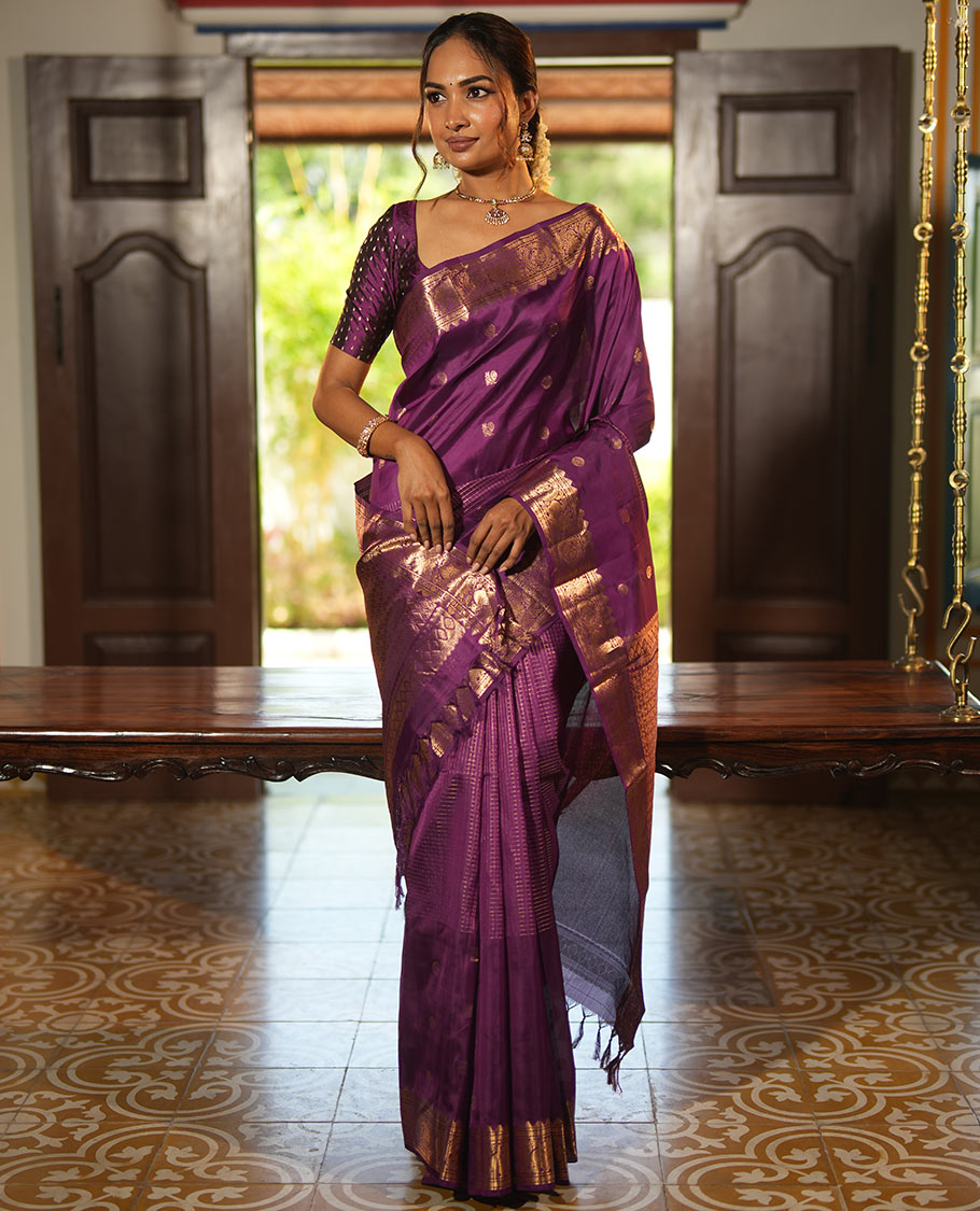 Purple Vasundhara Lite Silk Mix Saree, Artfully Detailed with Mayil-Chakram Buttas and Zari Checks All Over Its Body, Highlighted by a Zari Border of Thazampoo Rekkum, Paisa, Mayil, and Chakram Designs, a Grand Pallu, and Paired with a Matching Blouse