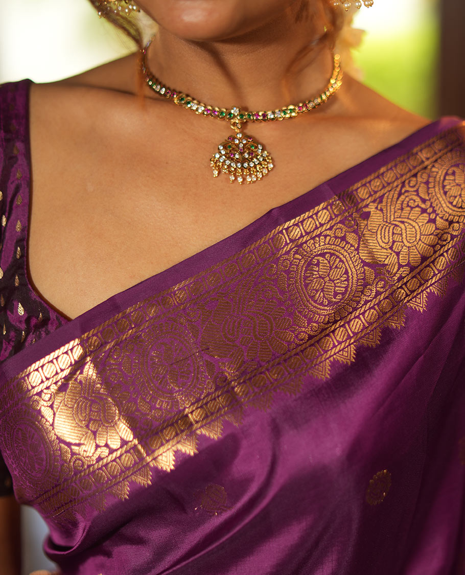 Purple Vasundhara Lite Silk Mix Saree, Artfully Detailed with Mayil-Chakram Buttas and Zari Checks All Over Its Body, Highlighted by a Zari Border of Thazampoo Rekkum, Paisa, Mayil, and Chakram Designs, a Grand Pallu, and Paired with a Matching Blouse