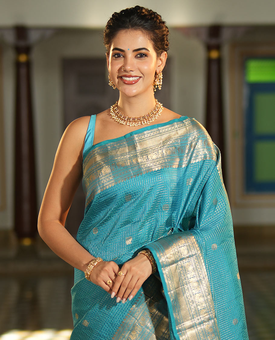 Blue Vasundhara Lite Silk Mix Saree, Richly Detailed with Zari Buttas and Zari Checks All Over Its Body, Highlighted by a Zari Border of Manga, Neli, Kamalam, Mayil, and Vanki Designs, Gleaming Intricately Designed Pallu, and Paired with a Matching Blouse