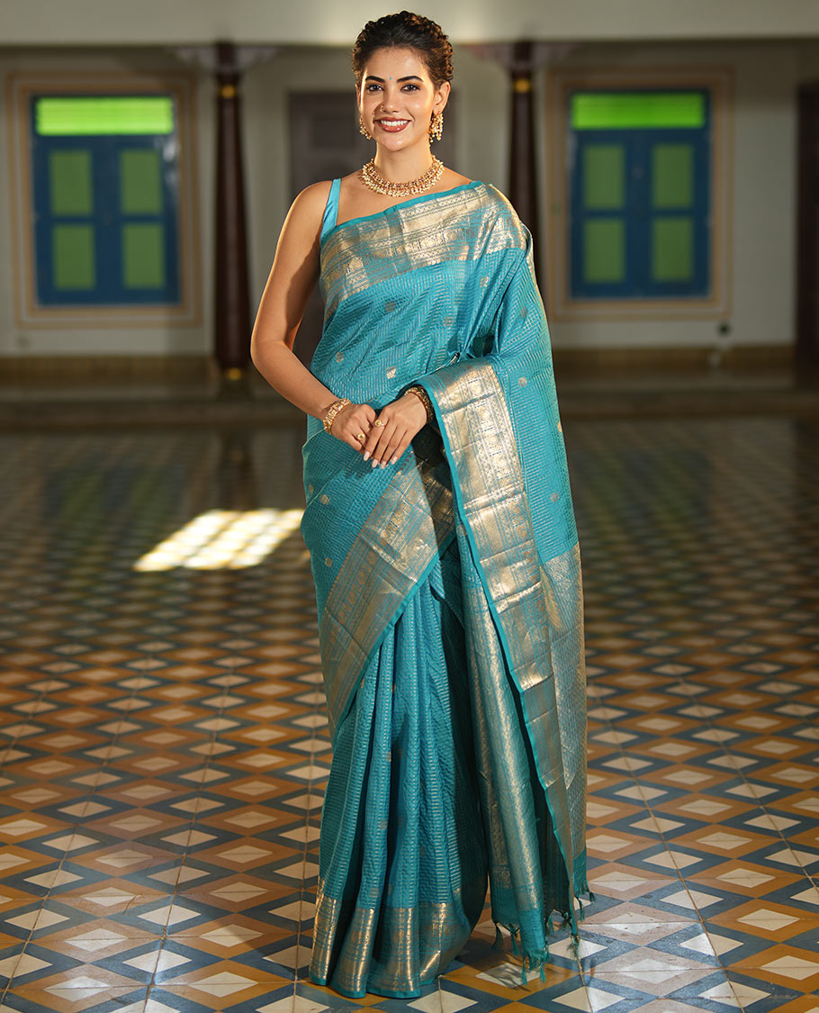 Blue Vasundhara Lite Silk Mix Saree, Richly Detailed with Zari Buttas and Zari Checks All Over Its Body, Highlighted by a Zari Border of Manga, Neli, Kamalam, Mayil, and Vanki Designs, Gleaming Intricately Designed Pallu, and Paired with a Matching Blouse