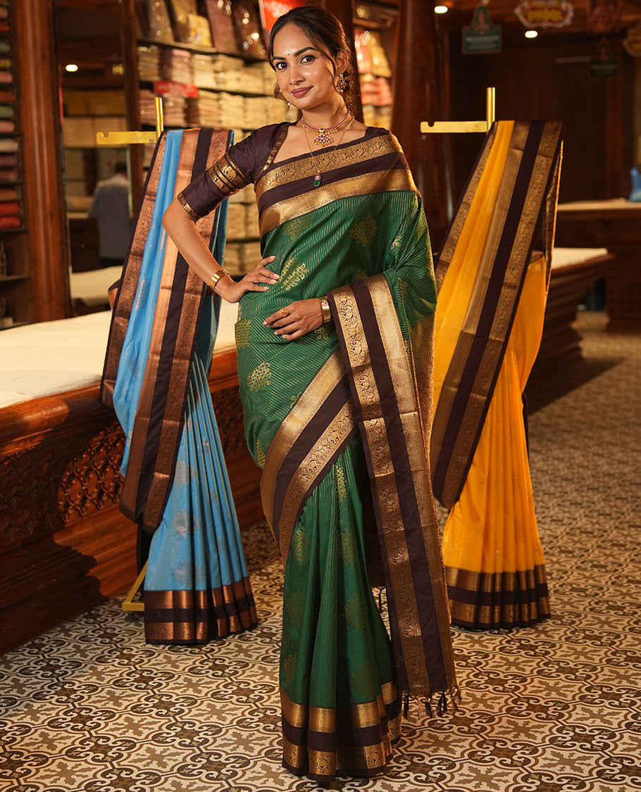 Green Budget Silk Saree, Delicately Woven with Zari Stripes and Kolam Buttas All Over Its Body, Complemented by a Contrast Traditional Zari Design Rettai Pettu Border, Grand Scallop Design Pallu, and Paired with a Contrast Blouse