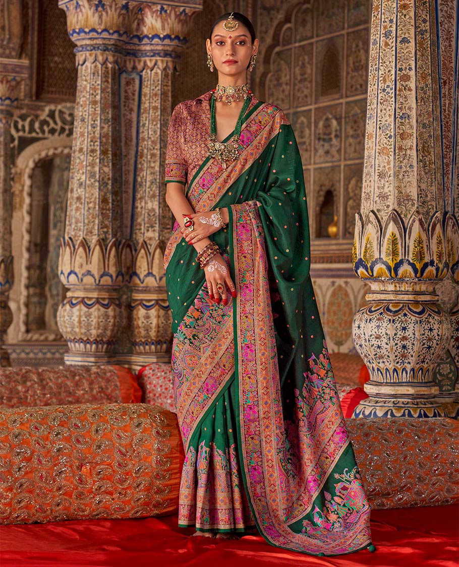 Bottle green meena buttas designer catalog saree, contrast meenakari border of human and elephant motifs, and wedding theme meenakari pallu