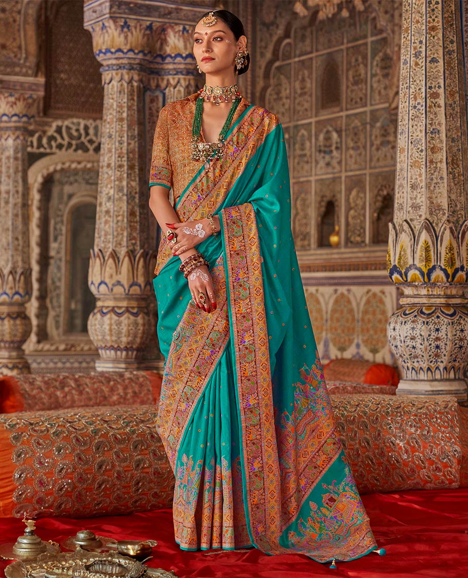 Light blue meena buttas designer catalog saree, contrast meenakari border of human and elephant motifs, and wedding theme meenakari pallu