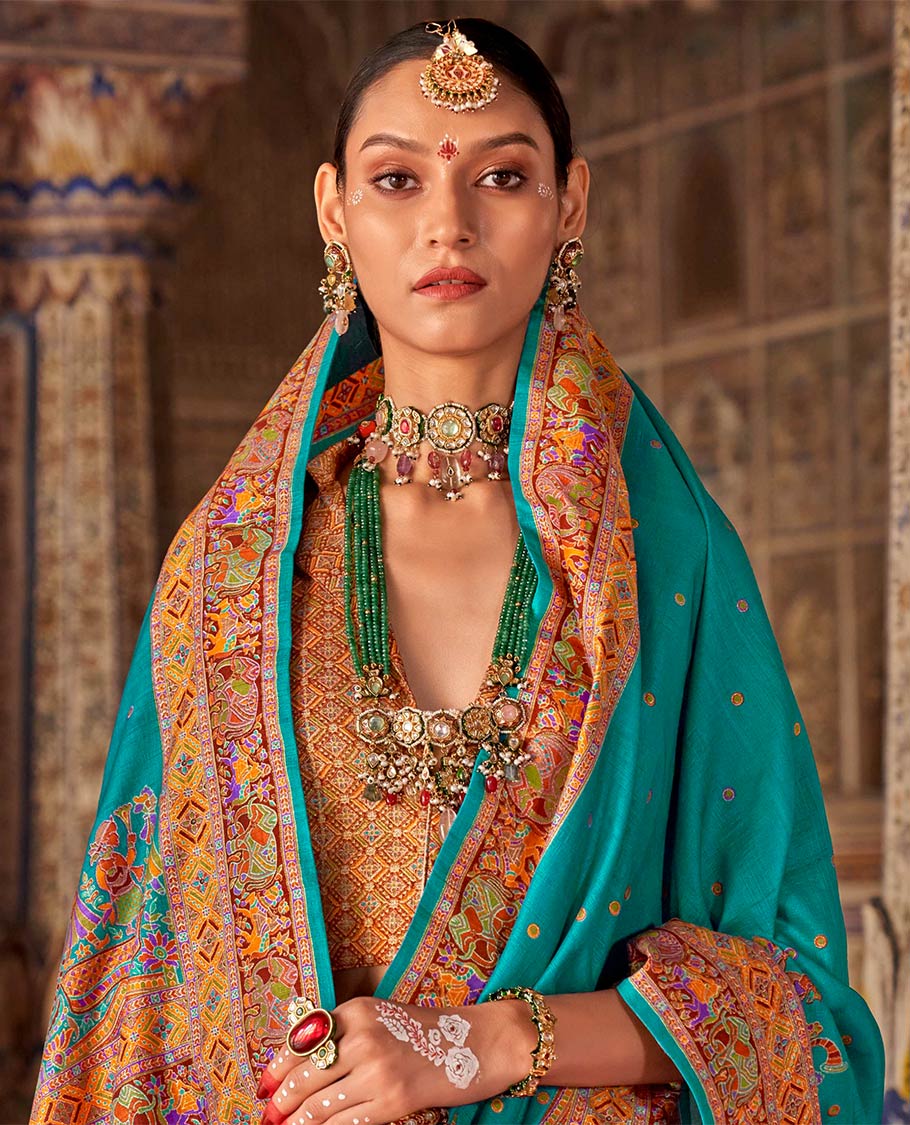 Light blue meena buttas designer catalog saree, contrast meenakari border of human and elephant motifs, and wedding theme meenakari pallu