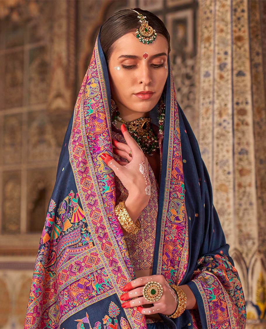 Navy blue meena buttas designer catalog saree, contrast meenakari border of human and elephant motifs, and wedding theme meenakari pallu