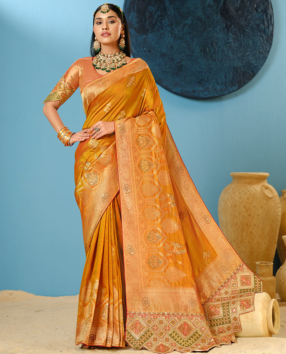 Orange Designer Saree Decked Up with Buttas and Micro-Stone Work, Featuring a Zari-Stonework Border, Intricately Embroidered Pallu, and a Contrast Embroidered Blouse